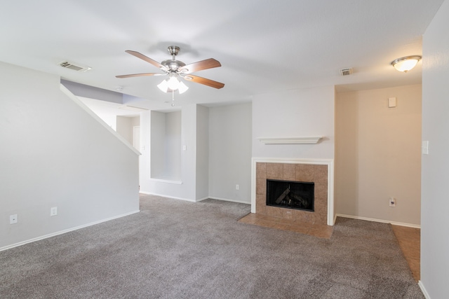 12026 Madison Oak St, Houston, TX 77038 - unfurnished living room featuring carpet, a tiled fireplace, and ceiling fan