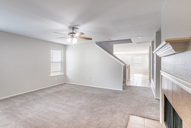 12026 Madison Oak St, Houston, TX 77038 - unfurnished living room with light carpet and a ceiling fan