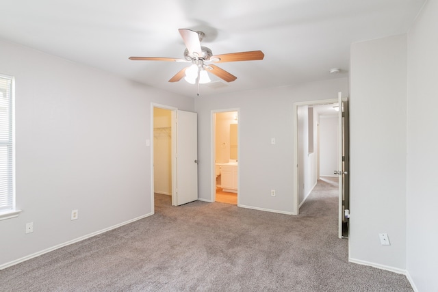 12026 Madison Oak St, Houston, TX 77038 - unfurnished bedroom featuring carpet floors, a spacious closet, ensuite bathroom, and ceiling fan