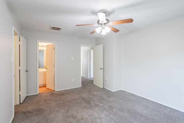 12026 Madison Oak St, Houston, TX 77038 - unfurnished bedroom featuring carpet floors, connected bathroom, and ceiling fan