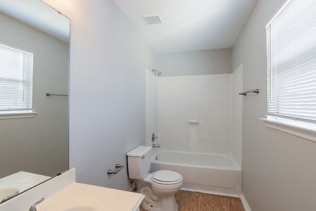 12026 Madison Oak St, Houston, TX 77038 - bathroom featuring vanity, wood finished floors, healthy amount of natural light, and tub / shower combination