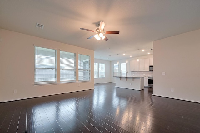 3414 Signor Dr, Houston, TX 77025 - unfurnished living room with ceiling fan, dark wood-style floors, and recessed lighting