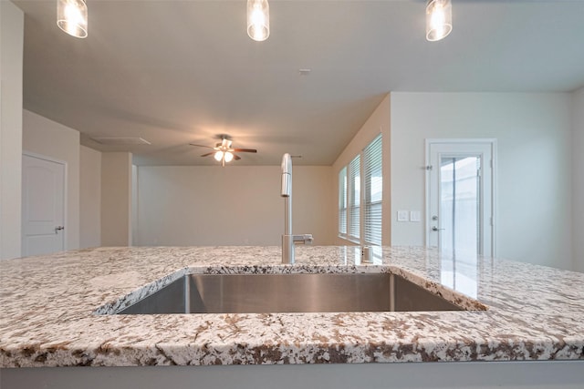 3414 Signor Dr, Houston, TX 77025 - kitchen featuring a ceiling fan, light stone counters, hanging light fixtures, and open floor plan