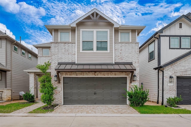3414 Signor Dr, Houston, TX 77025 - view of front of property featuring a standing seam roof, an attached garage, decorative driveway, a metal roof, and brick siding