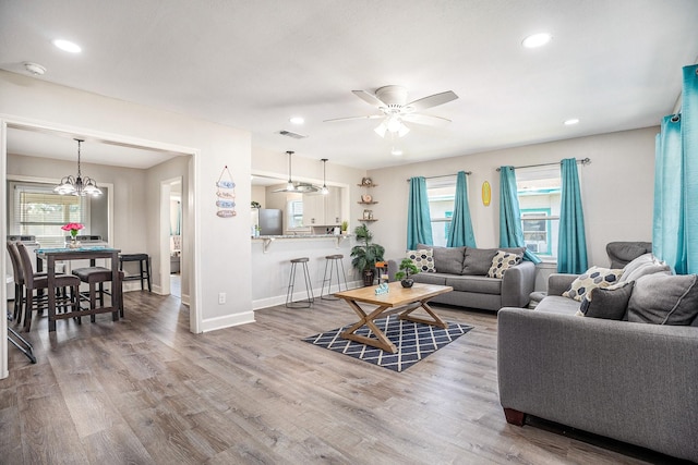 2315 67th St, Galveston, TX 77551 - living room with a ceiling fan, wood finished floors, recessed lighting, and a chandelier