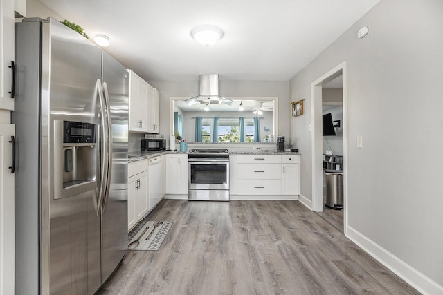2315 67th St, Galveston, TX 77551 - kitchen with stainless steel appliances, white cabinets, and light wood-type flooring