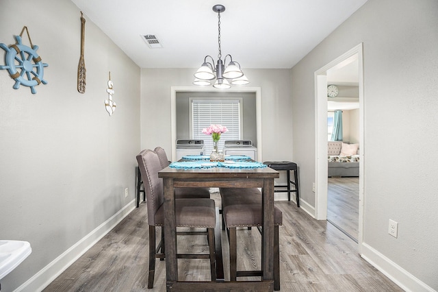 2315 67th St, Galveston, TX 77551 - dining space with wood finished floors and a chandelier