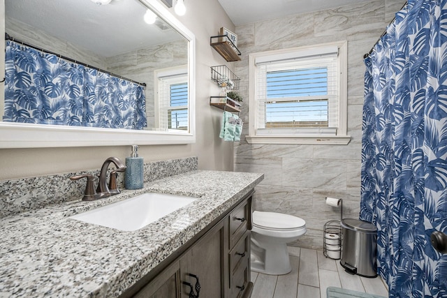 2315 67th St, Galveston, TX 77551 - full bath featuring tile walls, vanity, tile patterned flooring, and a shower with shower curtain