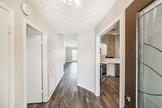 15806 Pfeiffer Dr, Houston, TX 77082 - hallway with a textured ceiling and dark wood-style floors