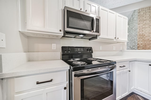 15806 Pfeiffer Dr, Houston, TX 77082 - kitchen featuring appliances with stainless steel finishes, white cabinets, and light countertops