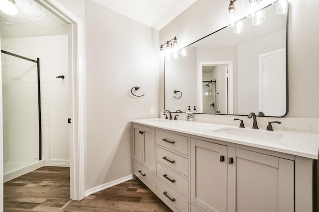 15806 Pfeiffer Dr, Houston, TX 77082 - full bath featuring wood finished floors, double vanity, and a shower stall