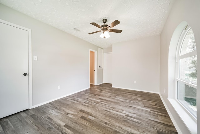15806 Pfeiffer Dr, Houston, TX 77082 - empty room with wood finished floors, a textured ceiling, and a ceiling fan