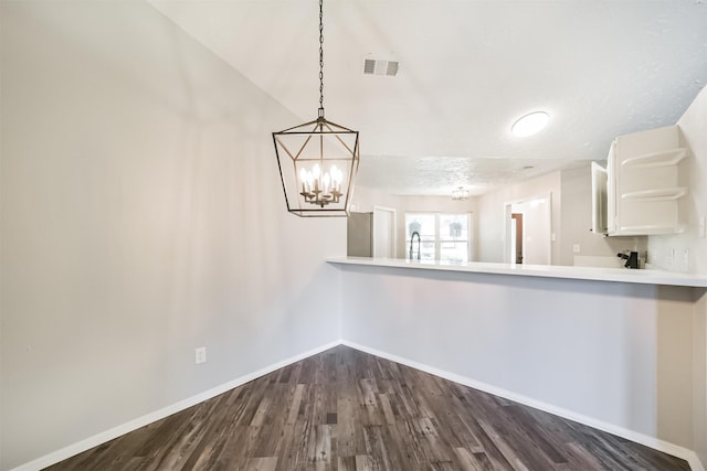 15806 Pfeiffer Dr, Houston, TX 77082 - unfurnished dining area with dark wood finished floors and a chandelier