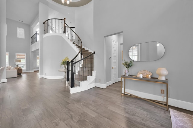 33 Violet Sunset Ln, Tomball, TX 77375 - entrance foyer with a high ceiling, stairway, plenty of natural light, wood finished floors, and a chandelier
