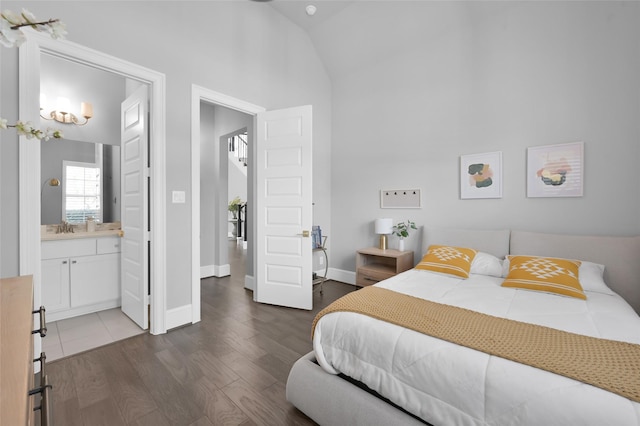 33 Violet Sunset Ln, Tomball, TX 77375 - bedroom featuring wood finished floors, ensuite bathroom, and high vaulted ceiling