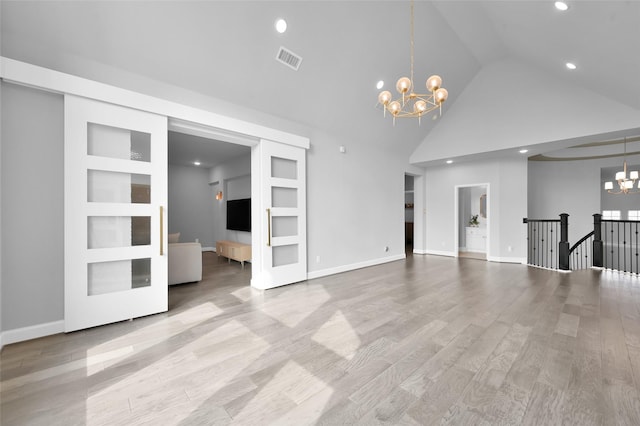 33 Violet Sunset Ln, Tomball, TX 77375 - unfurnished living room with a chandelier, recessed lighting, high vaulted ceiling, and wood finished floors