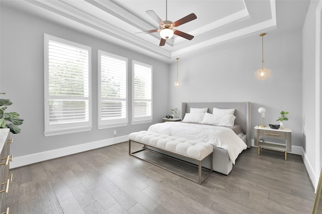 33 Violet Sunset Ln, Tomball, TX 77375 - bedroom featuring a raised ceiling, wood finished floors, and ceiling fan