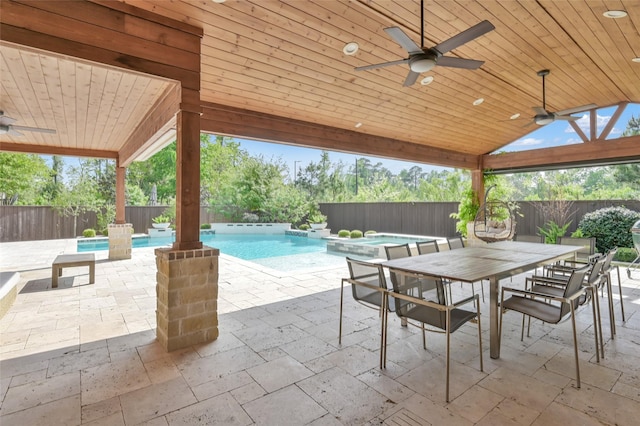 33 Violet Sunset Ln, Tomball, TX 77375 - fenced backyard featuring ceiling fan, a pool with connected hot tub, a patio, and outdoor dining space