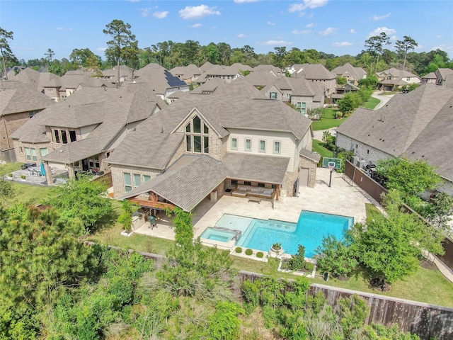 33 Violet Sunset Ln, Tomball, TX 77375 - back of house with a patio area, a fenced backyard, a residential view, a pool with connected hot tub, and roof with shingles