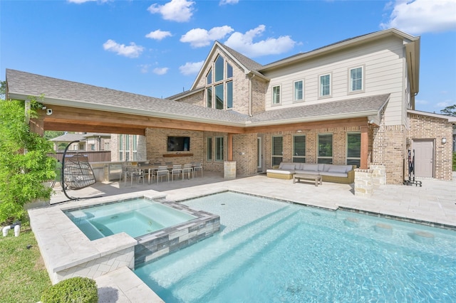 33 Violet Sunset Ln, Tomball, TX 77375 - rear view of property featuring brick siding, a patio area, an outdoor hangout area, and a pool with connected hot tub