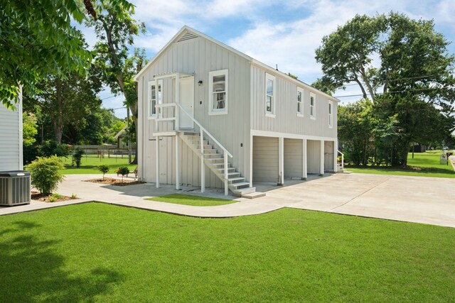 603 Hardeman St, Sealy, TX 77474 - rear view of property with driveway, stairs, and a yard