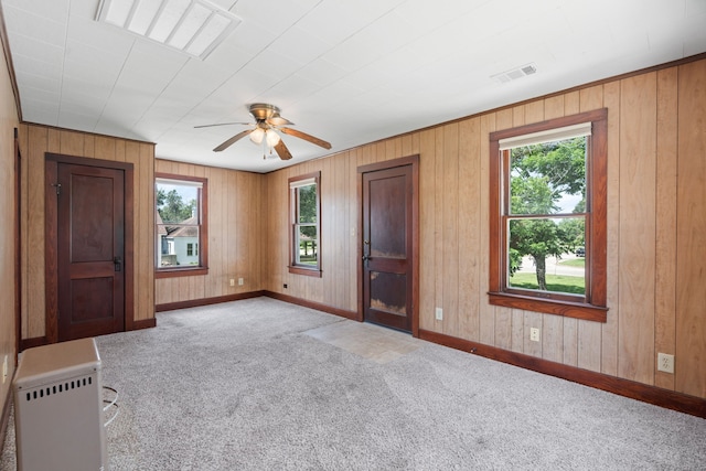 603 Hardeman St, Sealy, TX 77474 - spare room featuring light colored carpet, ceiling fan, and wooden walls