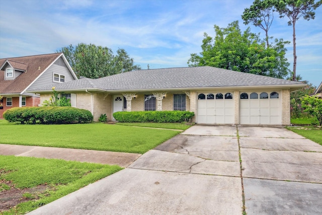 8210 Morley St, Houston, TX 77061 - view of front of home featuring brick siding, a garage, concrete driveway, a front lawn, and roof with shingles