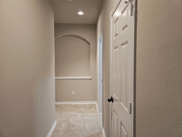3811 Pearl Pass Ln, Sugar Land, TX 77479 - corridor featuring a textured wall, light tile patterned flooring, and recessed lighting