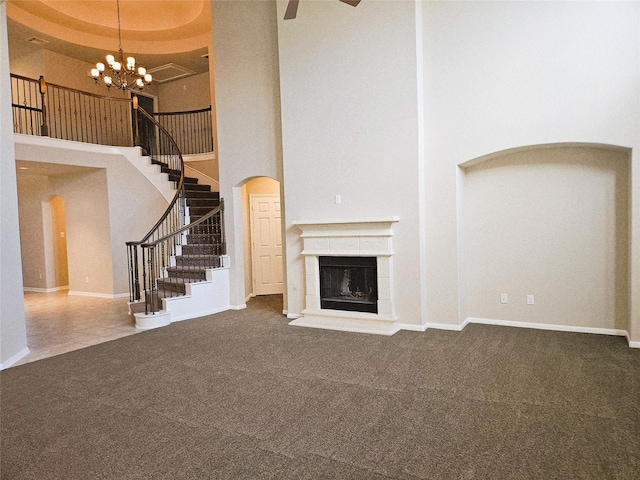 3811 Pearl Pass Ln, Sugar Land, TX 77479 - unfurnished living room with a towering ceiling, stairs, carpet, a chandelier, and a fireplace with raised hearth