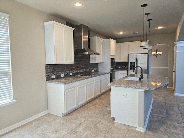 3811 Pearl Pass Ln, Sugar Land, TX 77479 - kitchen featuring appliances with stainless steel finishes, wall chimney range hood, tasteful backsplash, white cabinets, and recessed lighting