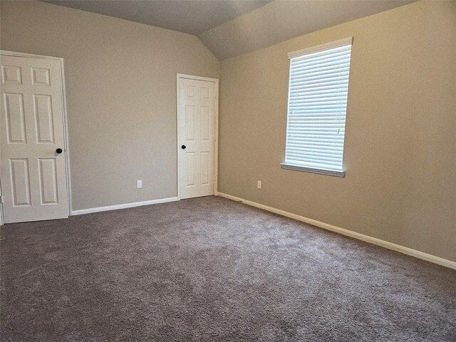 3811 Pearl Pass Ln, Sugar Land, TX 77479 - empty room featuring dark colored carpet and lofted ceiling