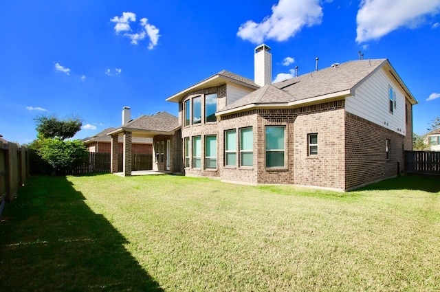 3811 Pearl Pass Ln, Sugar Land, TX 77479 - rear view of property featuring brick siding, a fenced backyard, a chimney, and roof with shingles