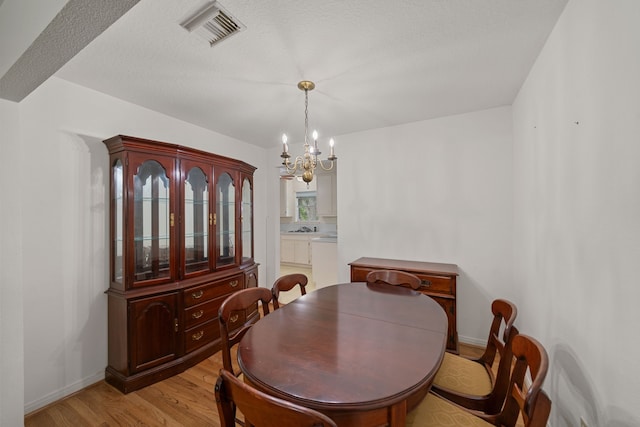 5006 Hazelton St, Houston, TX 77035 - dining area featuring a chandelier and light wood-type flooring