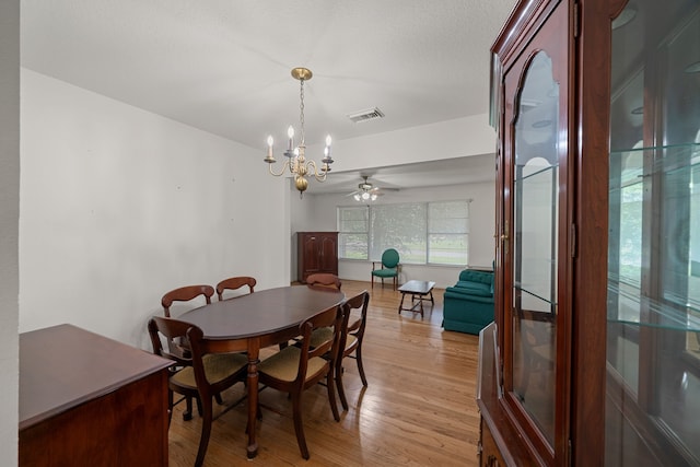 5006 Hazelton St, Houston, TX 77035 - dining space with light wood-style floors, ceiling fan, and a chandelier