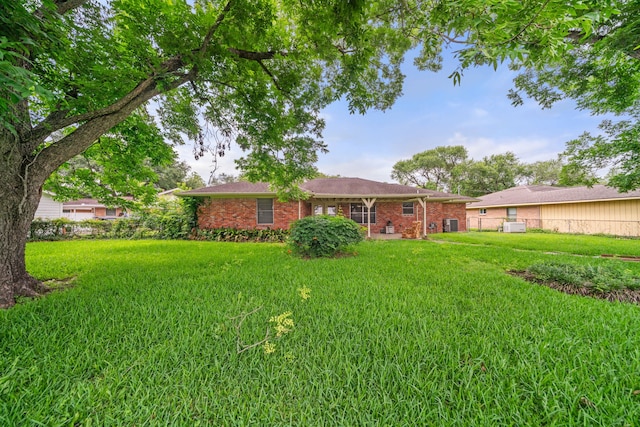 5006 Hazelton St, Houston, TX 77035 - back of property featuring a lawn and brick siding