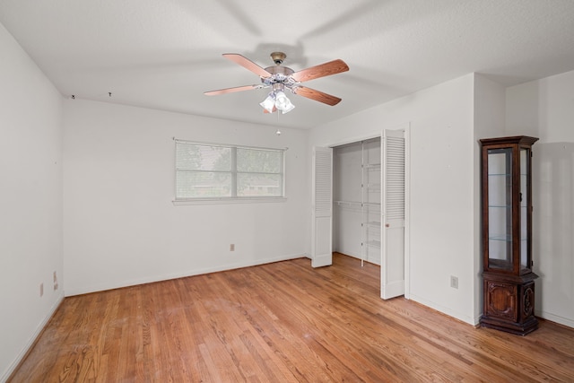 5006 Hazelton St, Houston, TX 77035 - unfurnished bedroom with light wood finished floors, a ceiling fan, and a closet