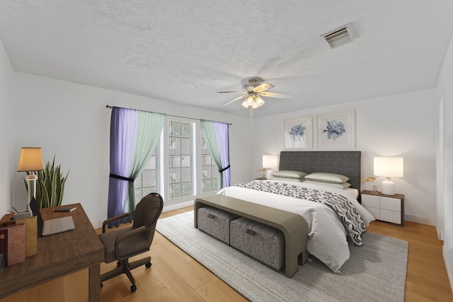 11614 Brighton Ln, Meadows Place, TX 77477 - bedroom with light wood-type flooring, ceiling fan, a textured ceiling, and a desk