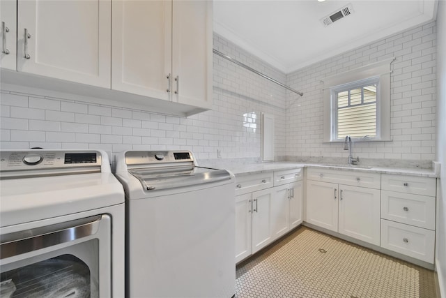 811 Byrne St, Houston, TX 77009 - laundry area with washer and dryer, cabinet space, and crown molding