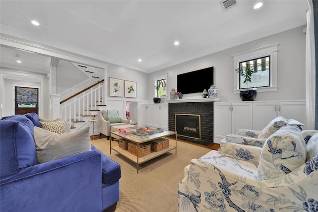 811 Byrne St, Houston, TX 77009 - living room with stairway, a brick fireplace, recessed lighting, a decorative wall, and wainscoting