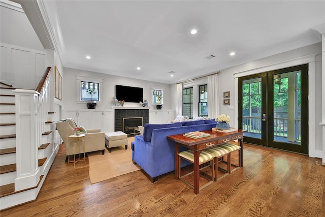 811 Byrne St, Houston, TX 77009 - living room with stairway, wood finished floors, a fireplace, french doors, and recessed lighting