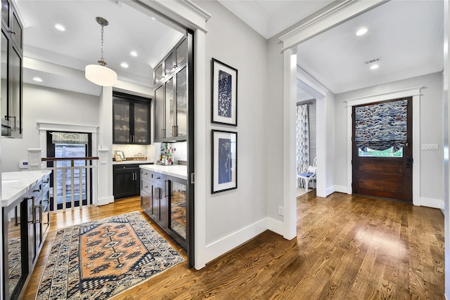 811 Byrne St, Houston, TX 77009 - indoor dry bar with wine cooler, wood finished floors, recessed lighting, hanging light fixtures, and ornamental molding