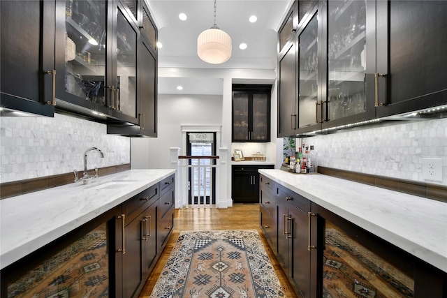 811 Byrne St, Houston, TX 77009 - indoor wet bar featuring decorative backsplash, hanging light fixtures, light wood-type flooring, and recessed lighting