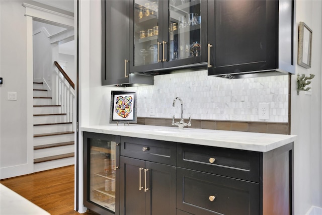 811 Byrne St, Houston, TX 77009 - bar featuring beverage cooler, decorative backsplash, stairs, and dark wood-type flooring