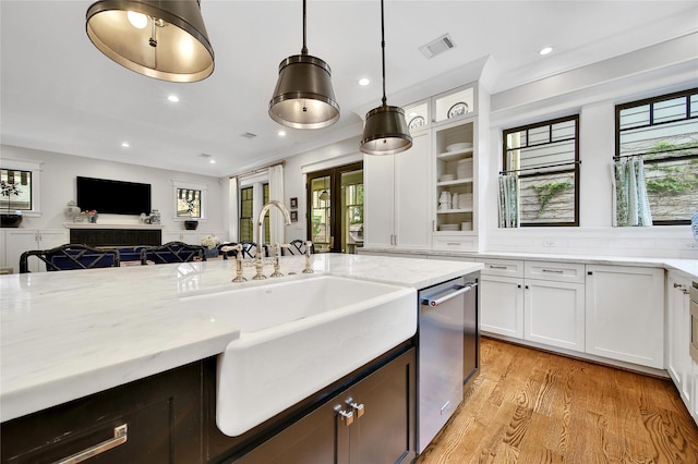 811 Byrne St, Houston, TX 77009 - kitchen featuring light stone countertops, white cabinetry, stainless steel dishwasher, healthy amount of natural light, and recessed lighting