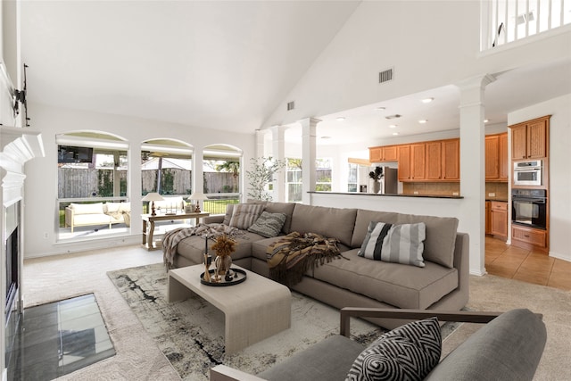 7611 Highmeadow Dr, Houston, TX 77063 - living area with decorative columns, light colored carpet, high vaulted ceiling, a fireplace with flush hearth, and light tile patterned floors