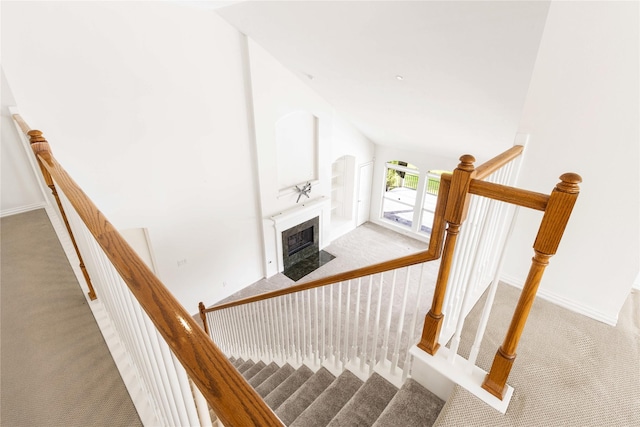 7611 Highmeadow Dr, Houston, TX 77063 - stairs featuring carpet, a fireplace with flush hearth, and lofted ceiling