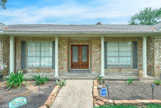 15402 Ripplestream, Houston, TX 77068 - doorway to property with brick siding, a porch, and a shingled roof
