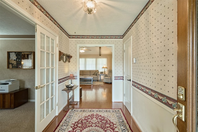 15402 Ripplestream, Houston, TX 77068 - corridor with a textured ceiling, wallpapered walls, ornamental molding, wood finished floors, and french doors