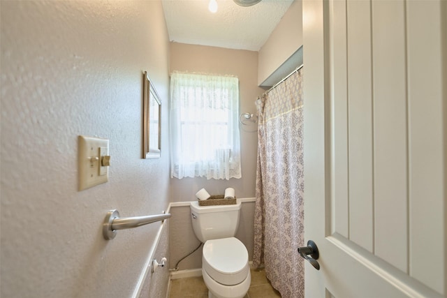 15402 Ripplestream, Houston, TX 77068 - bathroom featuring tile patterned flooring, a textured ceiling, and a shower with shower curtain