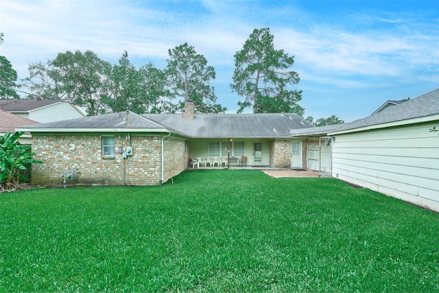 15402 Ripplestream, Houston, TX 77068 - back of house featuring a yard, a chimney, a patio, brick siding, and roof with shingles